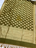 Green fabric with intricate patterns and a border on a white background