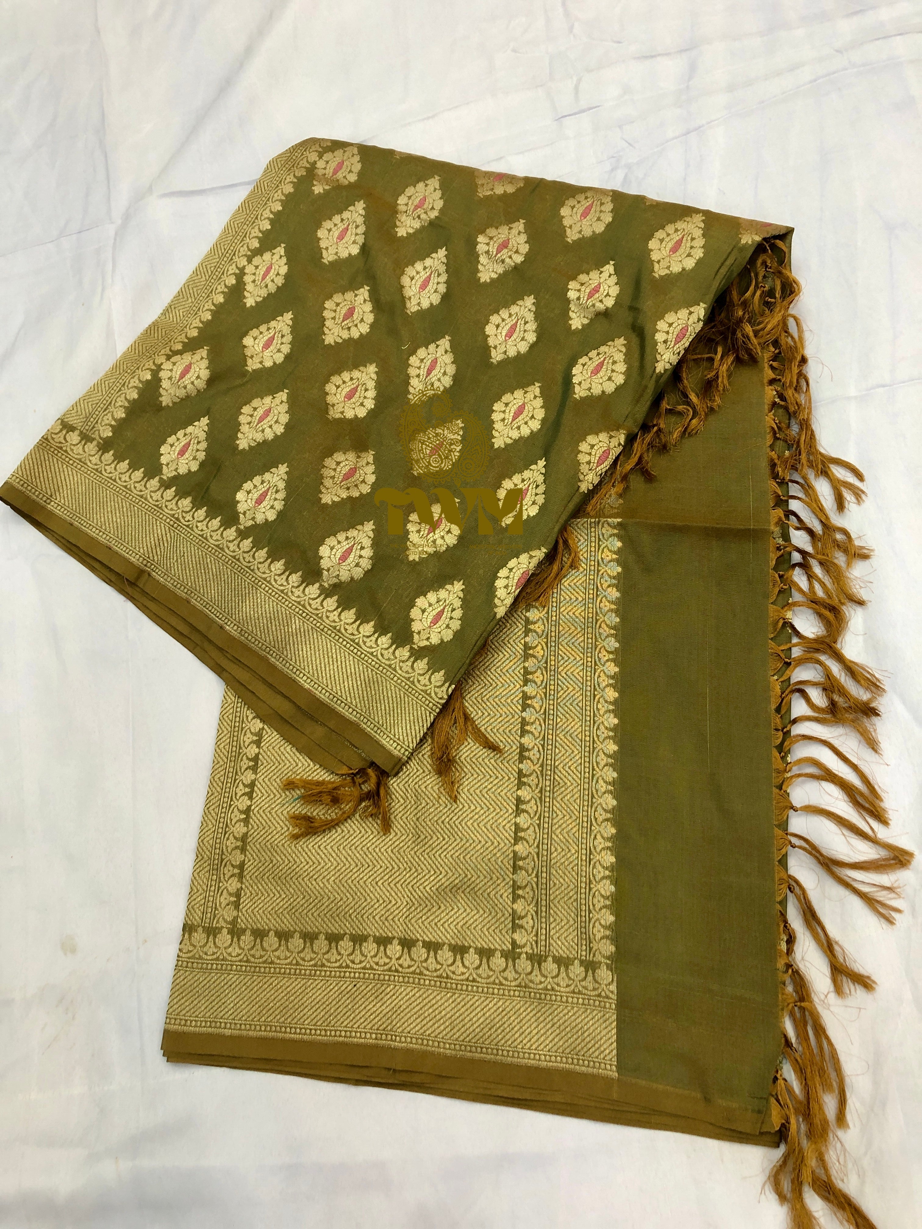 Green and beige patterned fabric with tassels on a white background