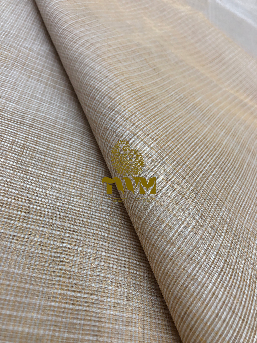 Textured beige fabric with a visible brand logo in the corner