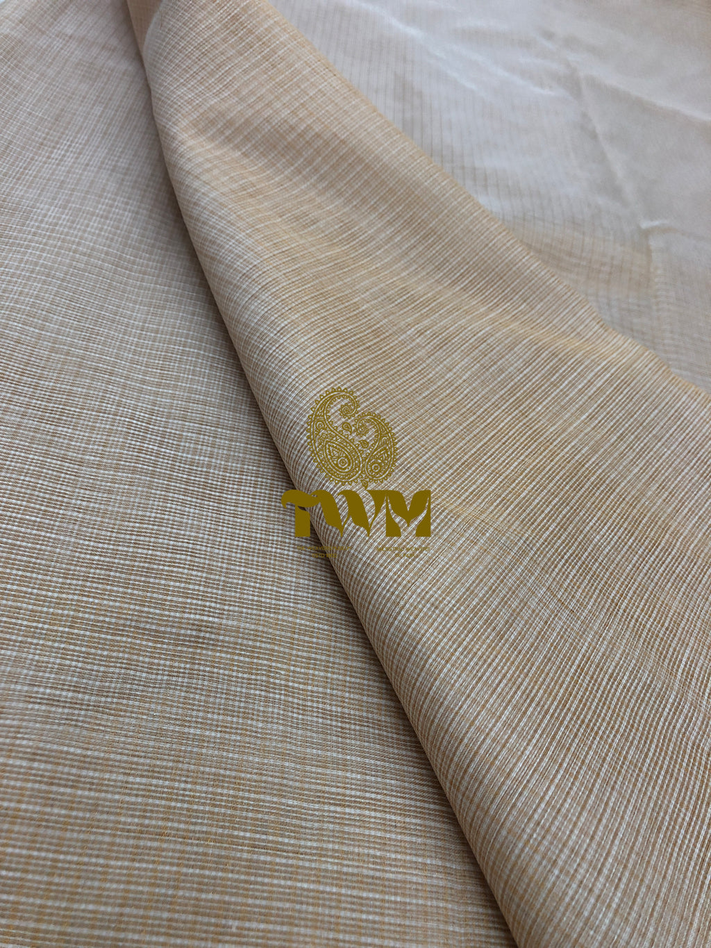 Beige fabric with a gold logo on a white background
