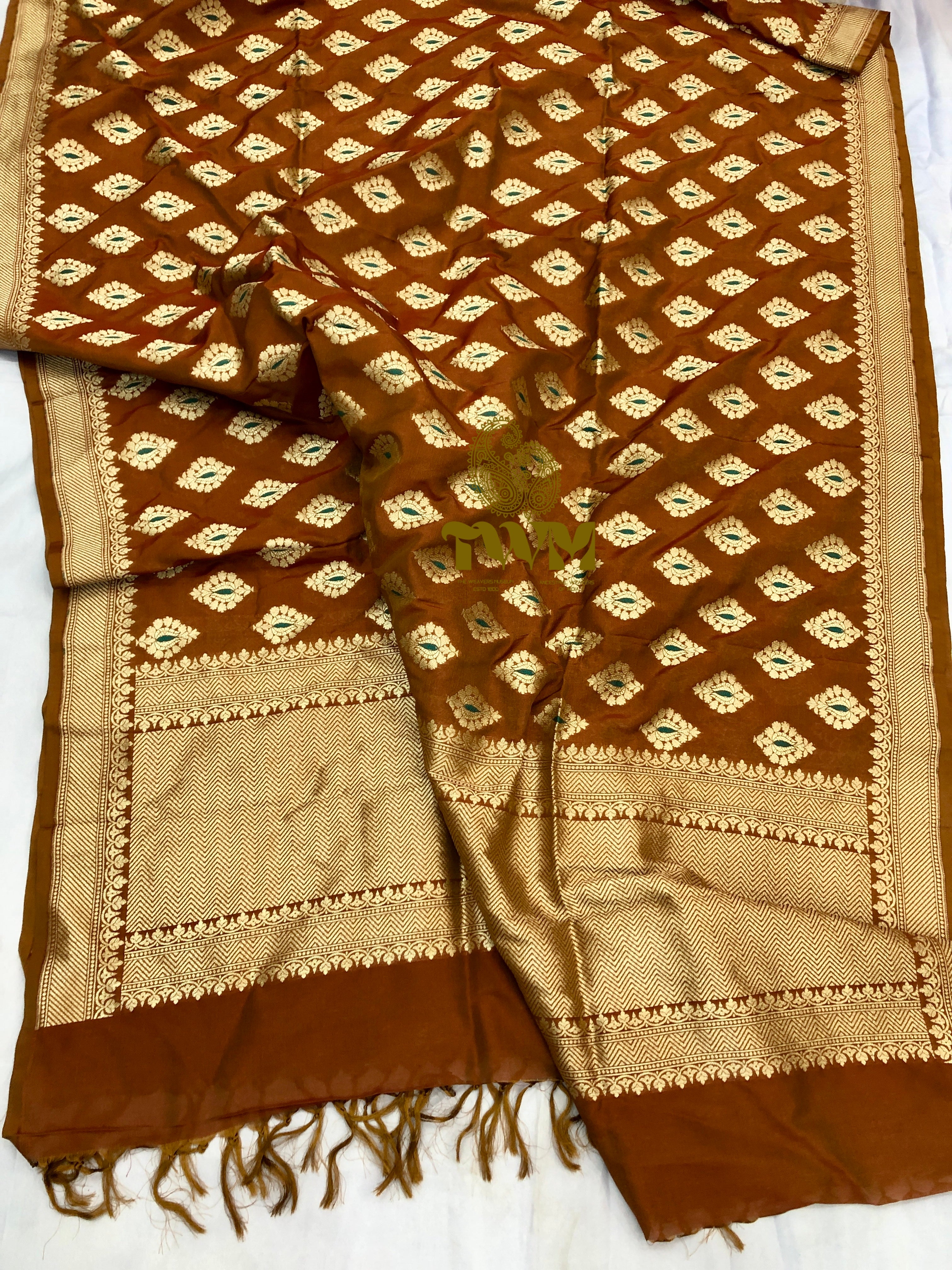 Brown and beige patterned fabric with tassels on a white background