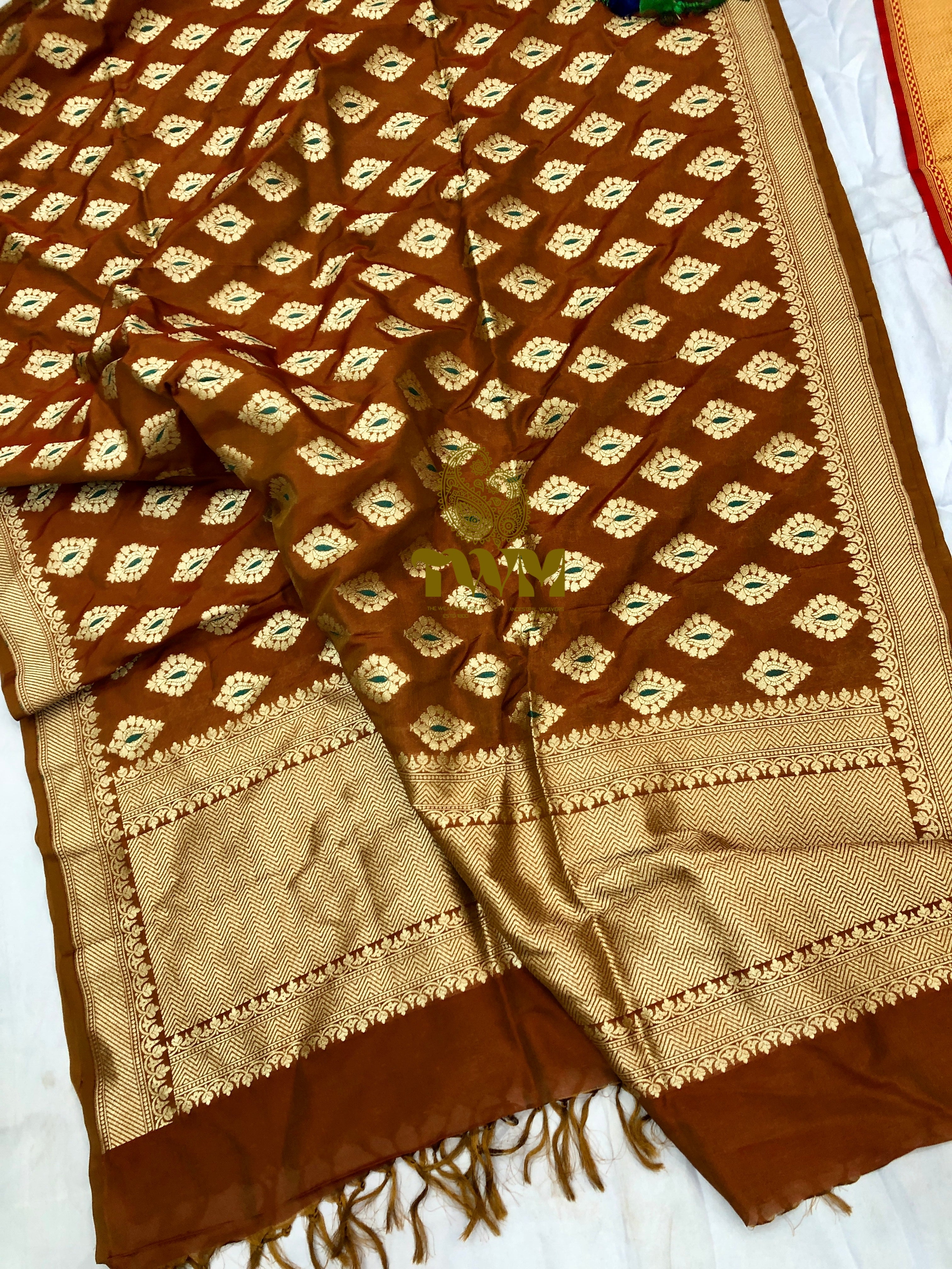 Brown and beige patterned fabric with fringes on a white background