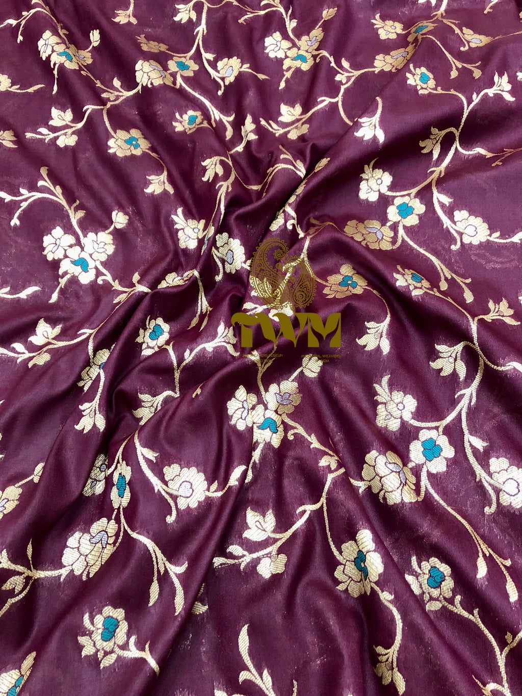 Burgundy fabric with floral embroidery and 'TWM' branding.