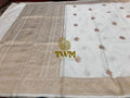 White fabric with gold embroidery and a logo in the center