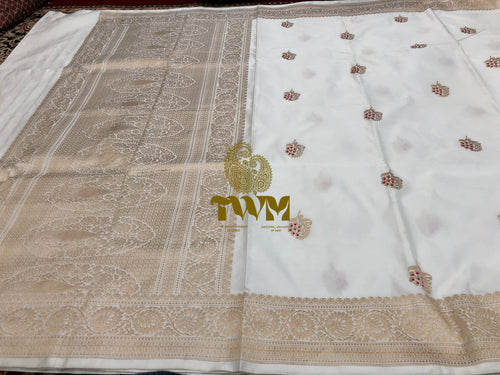 White fabric with gold embroidery and a logo in the center