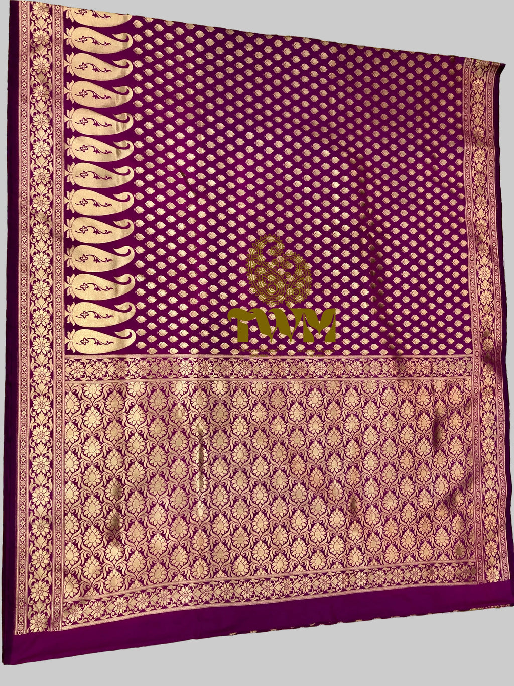Purple fabric with intricate patterns on a floral background