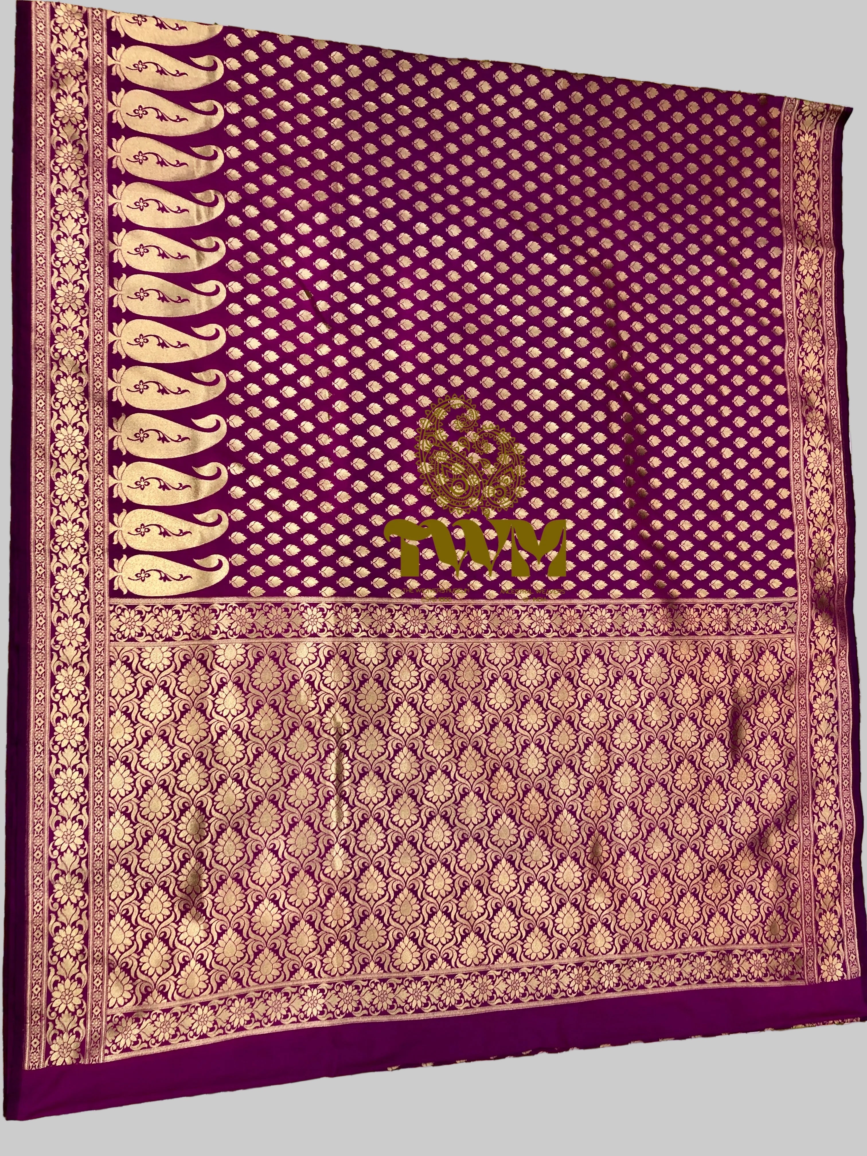 Purple fabric with intricate patterns on a floral background