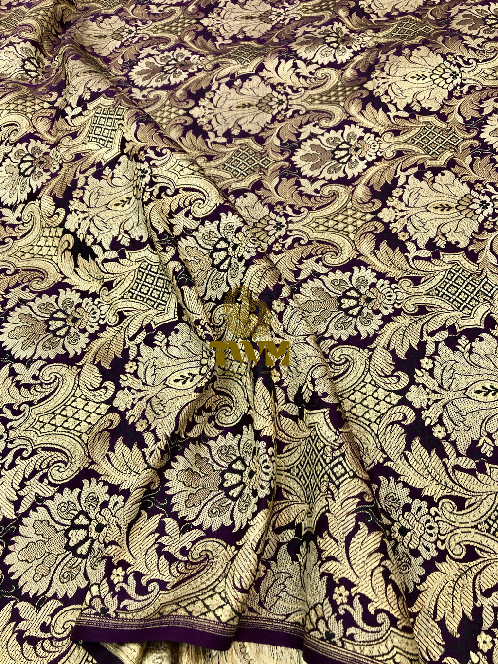 Decorative fabric with intricate black and gold pattern