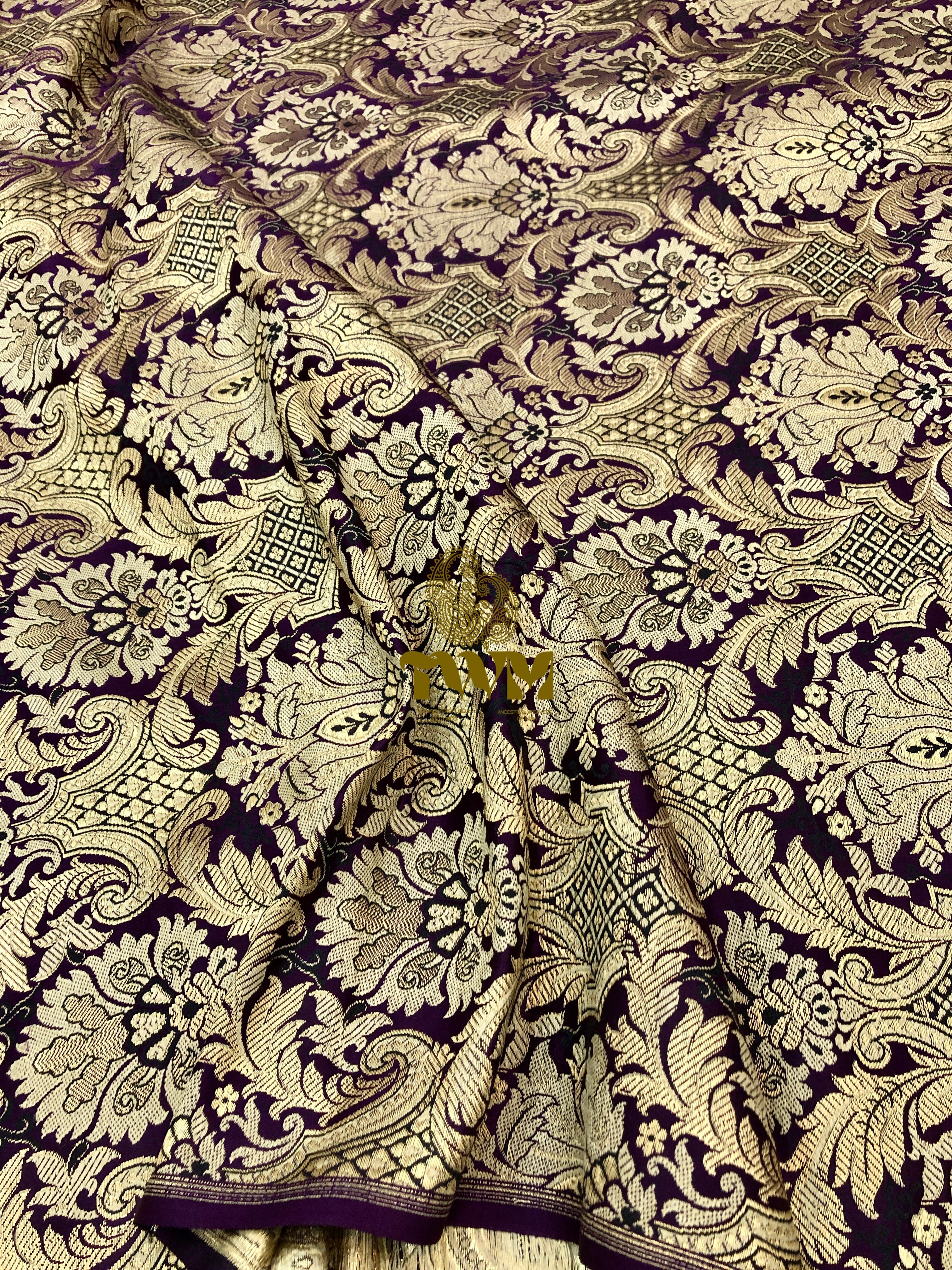 Decorative fabric with intricate black and gold pattern