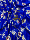Blue fabric with floral embroidery and 'TWM' branding