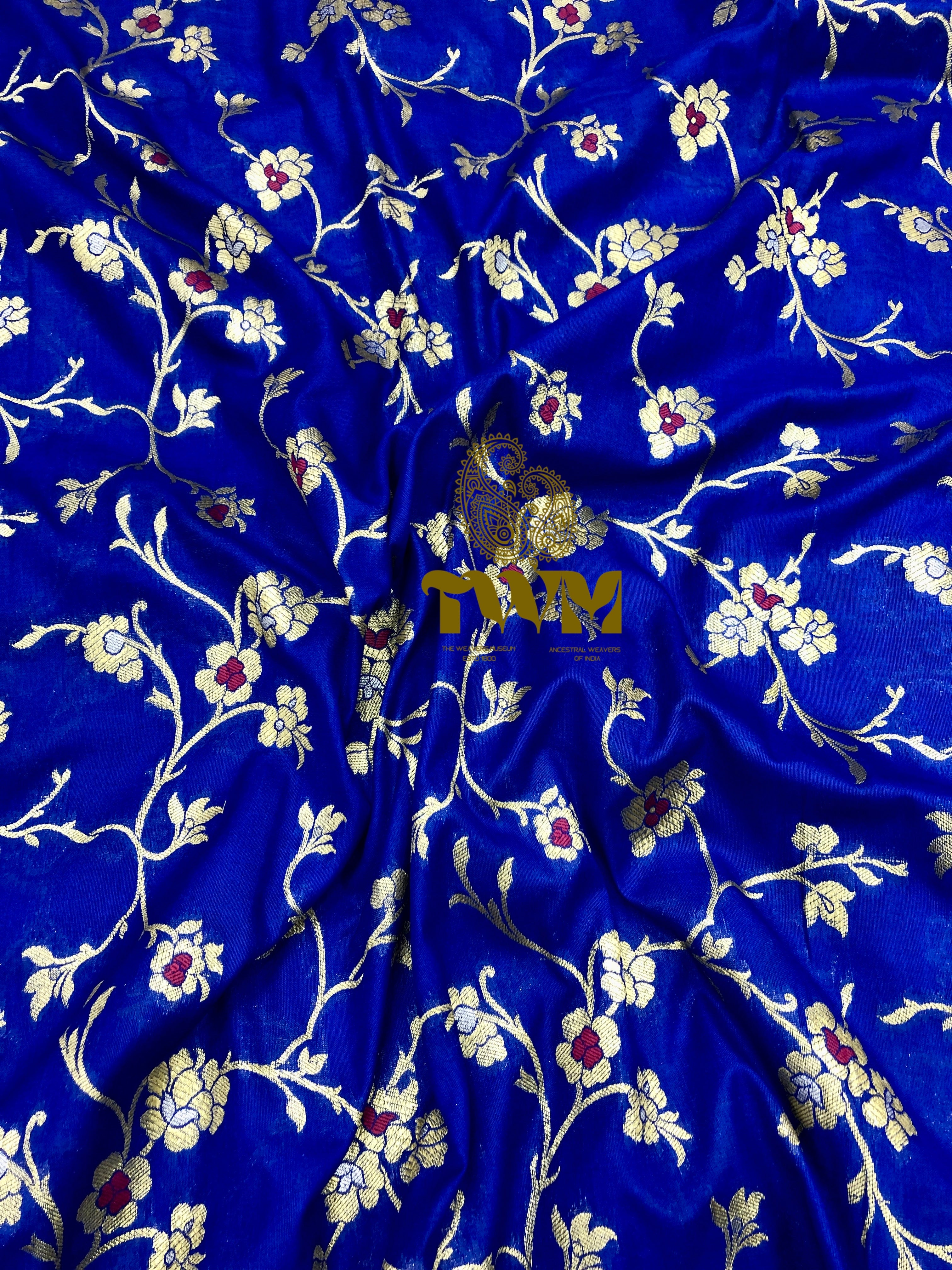 Blue fabric with floral patterns and a brand logo in the center