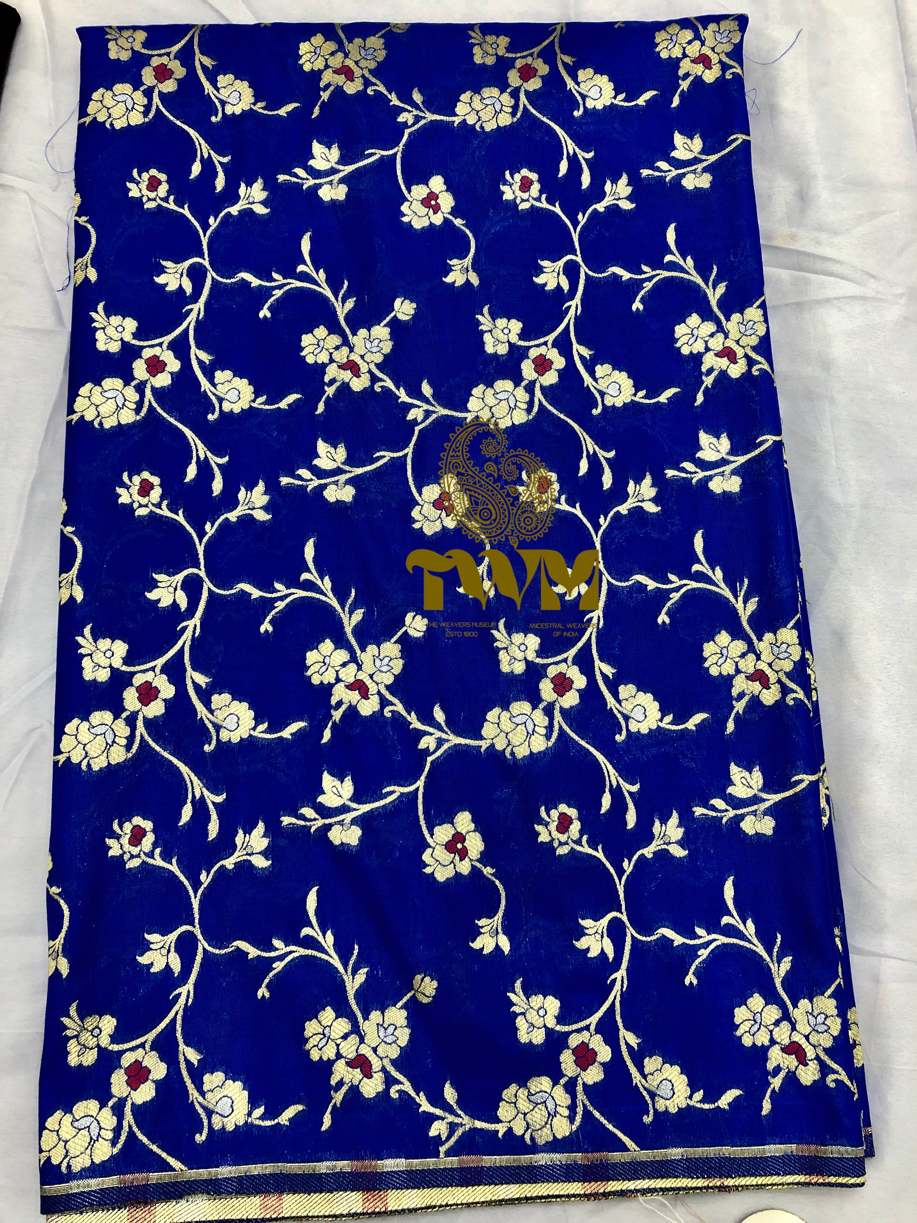 Blue fabric with floral patterns and a brand name on a white background
