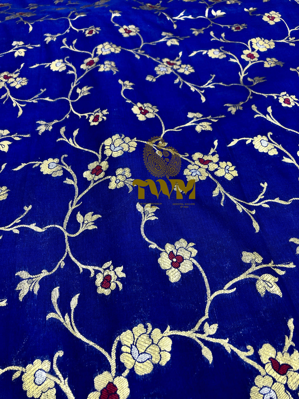 Embroidered fabric with floral patterns on a blue background