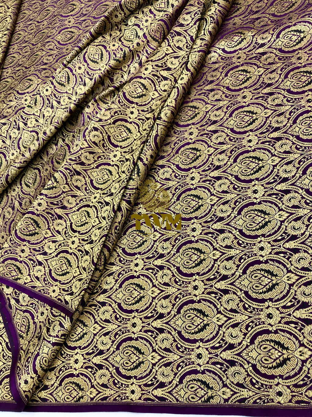 Patterned fabric with purple and gold design