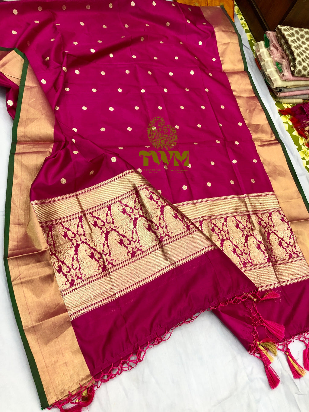 Rani magenta  saree with gold patterns on a white background