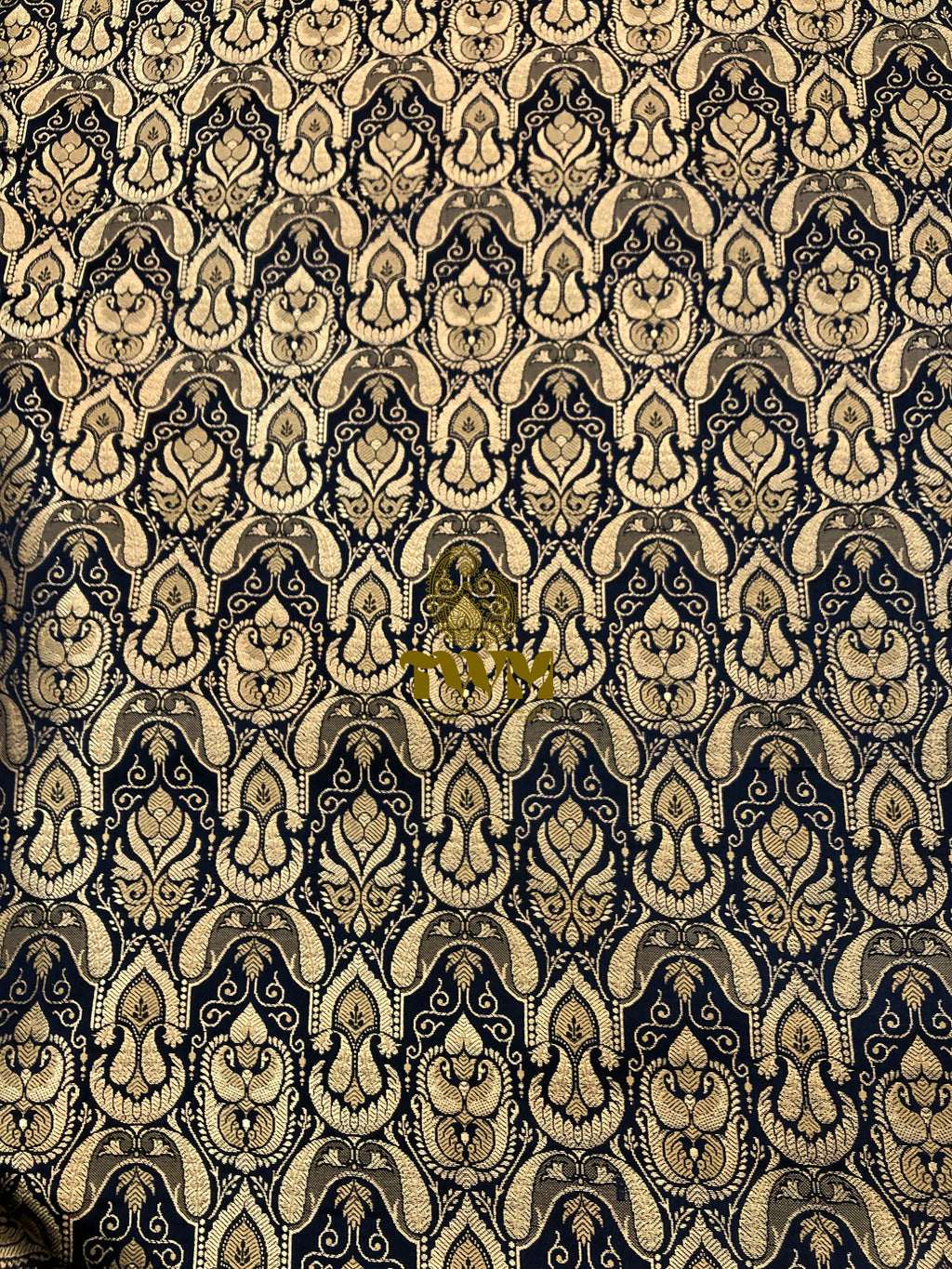 Decorative patterned fabric with intricate design on a black background