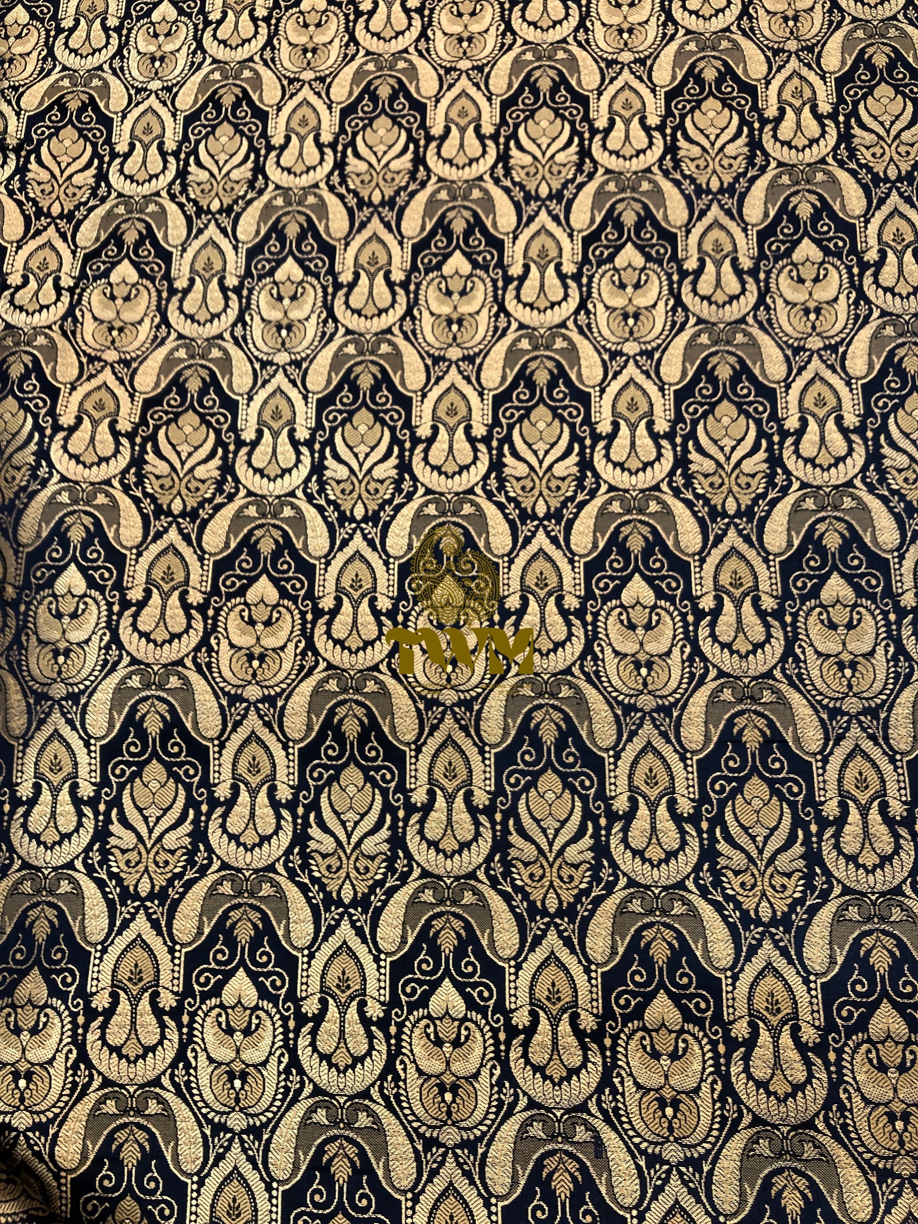 Decorative patterned fabric with intricate design on a black background