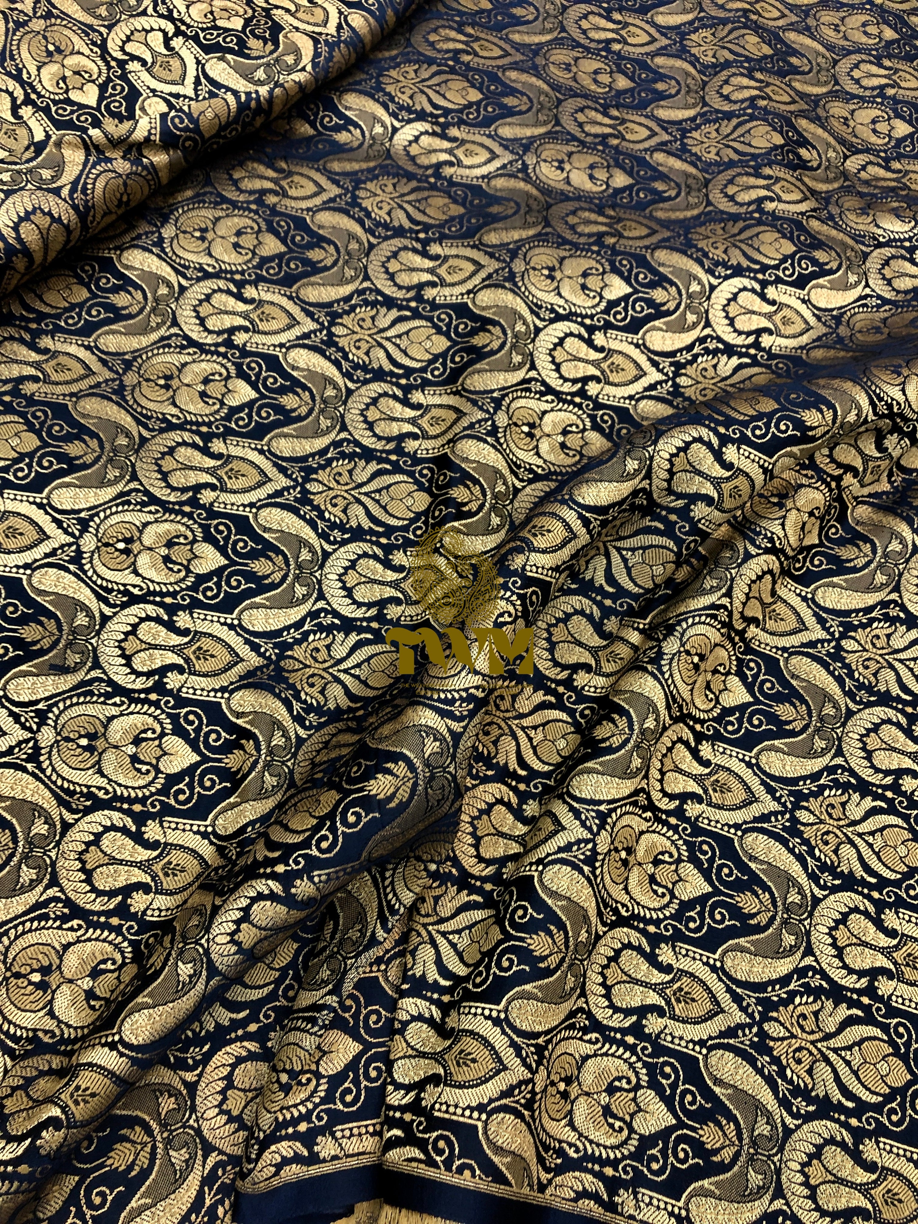 Patterned fabric with intricate design in gold and navy blue