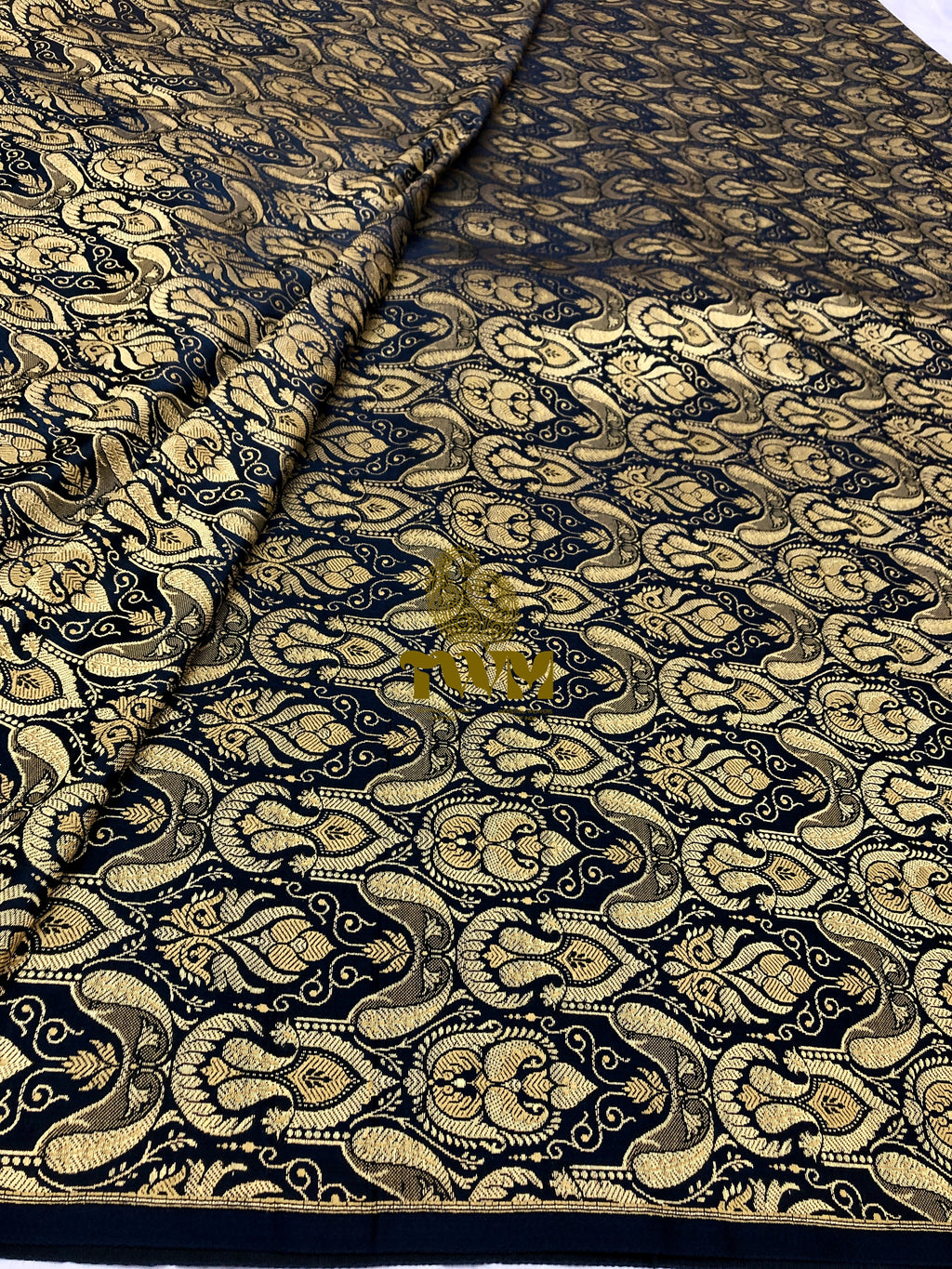 Patterned fabric with intricate design on a black background