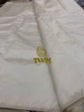 White fabric with a gold logo and text on a white background