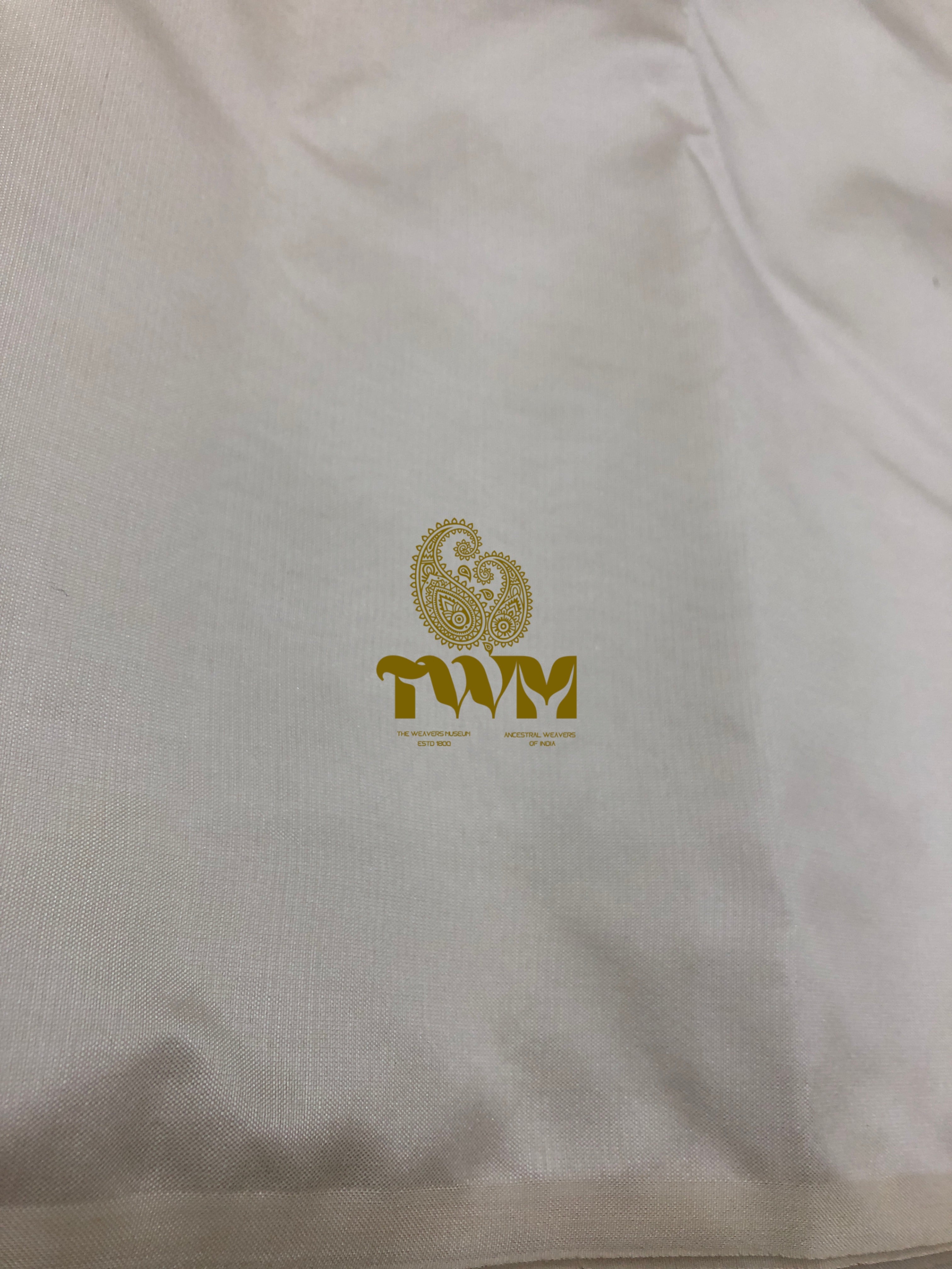 White shirt with gold logo and text on a plain background