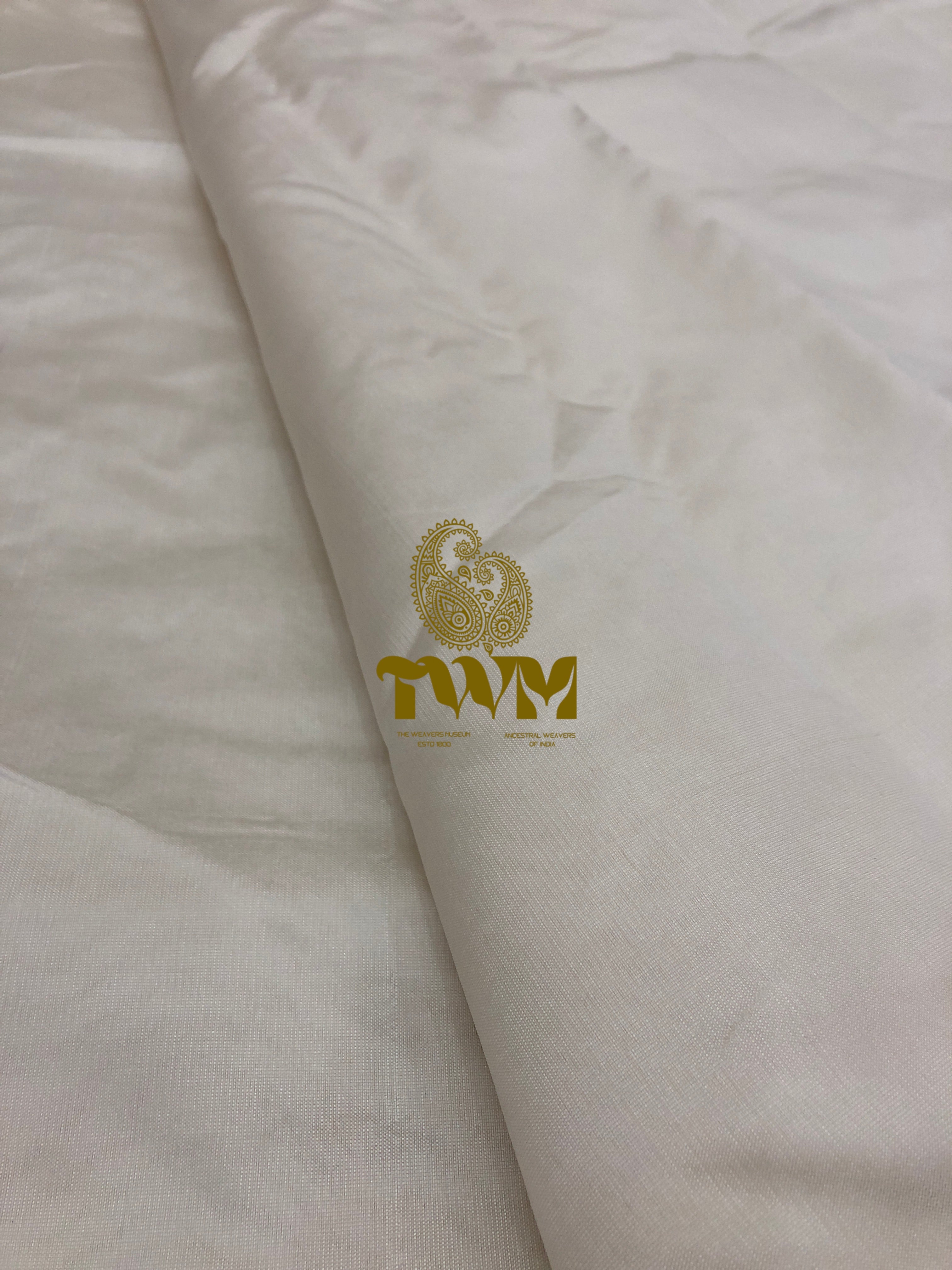 White fabric with gold logo and text on a white background