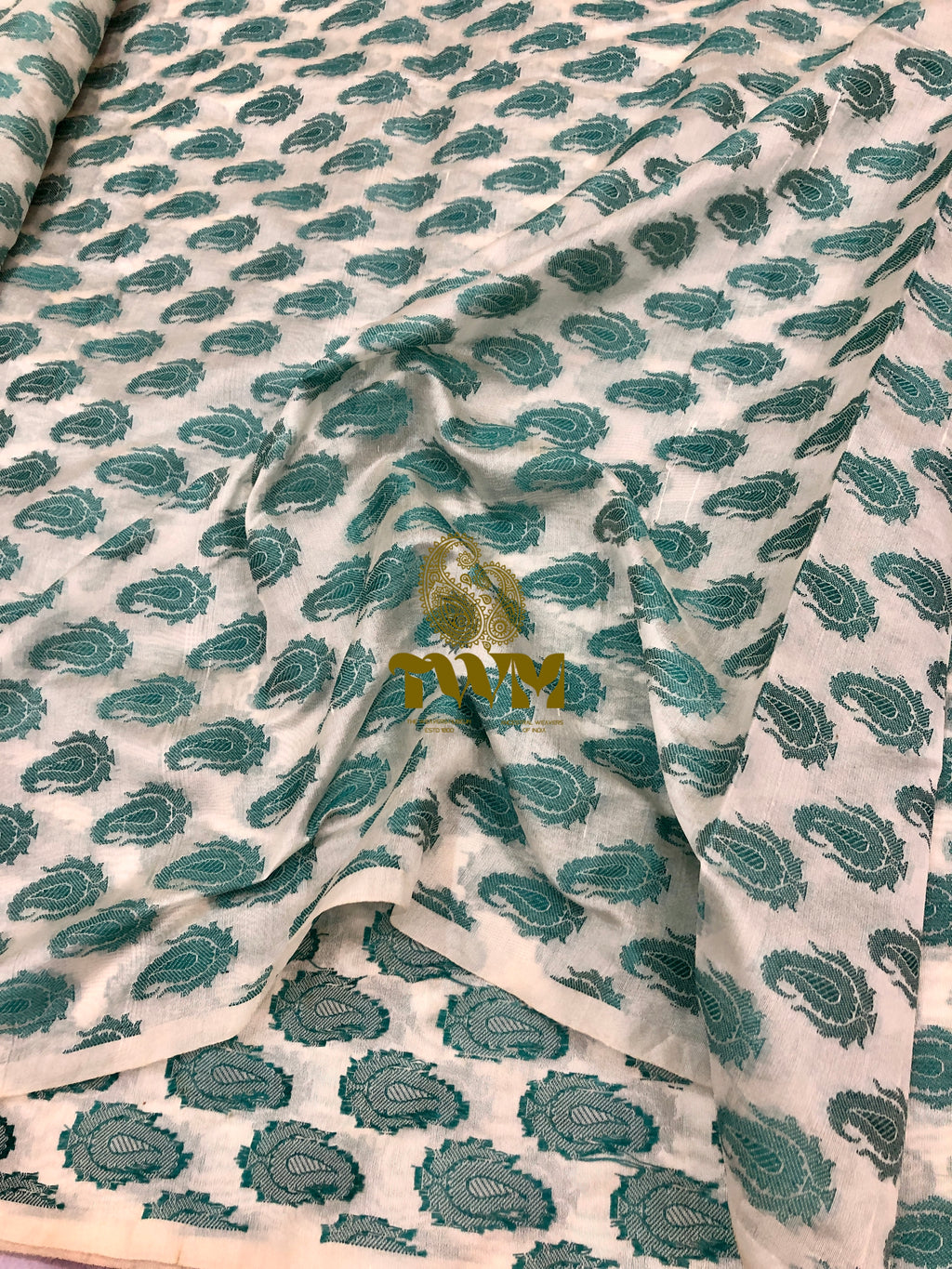 Fabric with green floral pattern on a white background