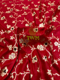 Red fabric with floral patterns and a visible brand logo in the center.