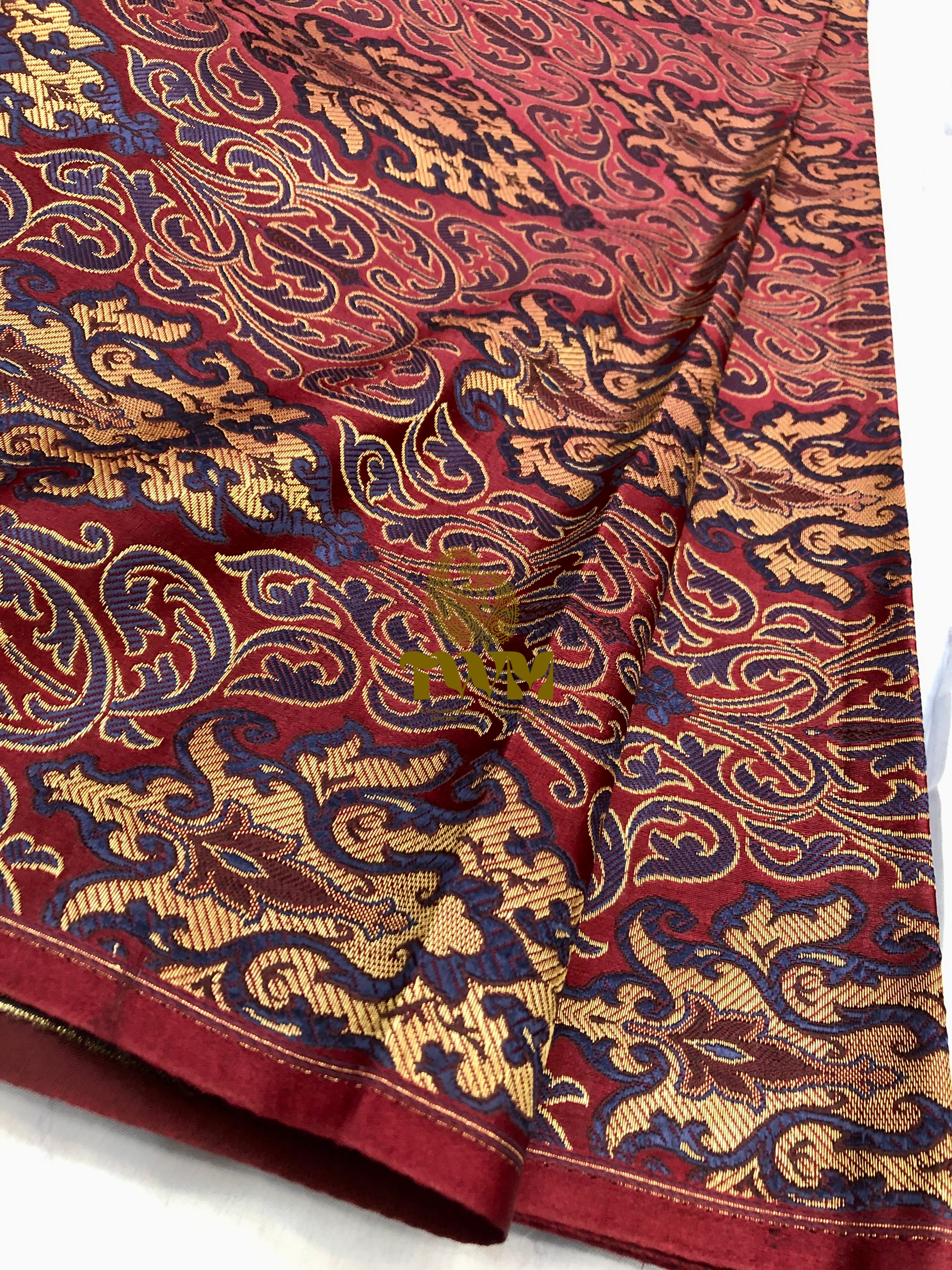 Close-up of a patterned fabric with intricate designs on a white background
