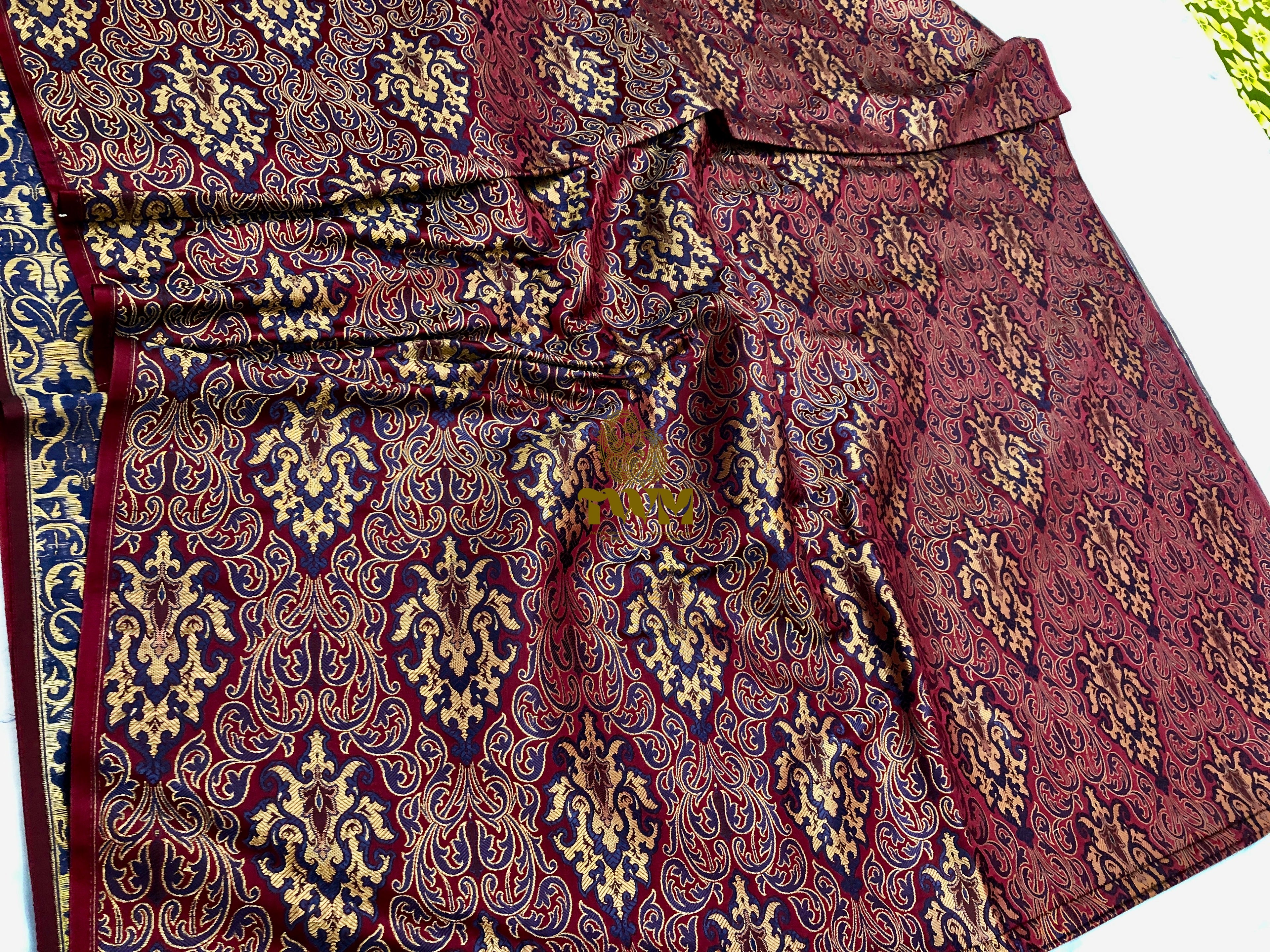 Close-up of a patterned fabric with intricate designs on a white background