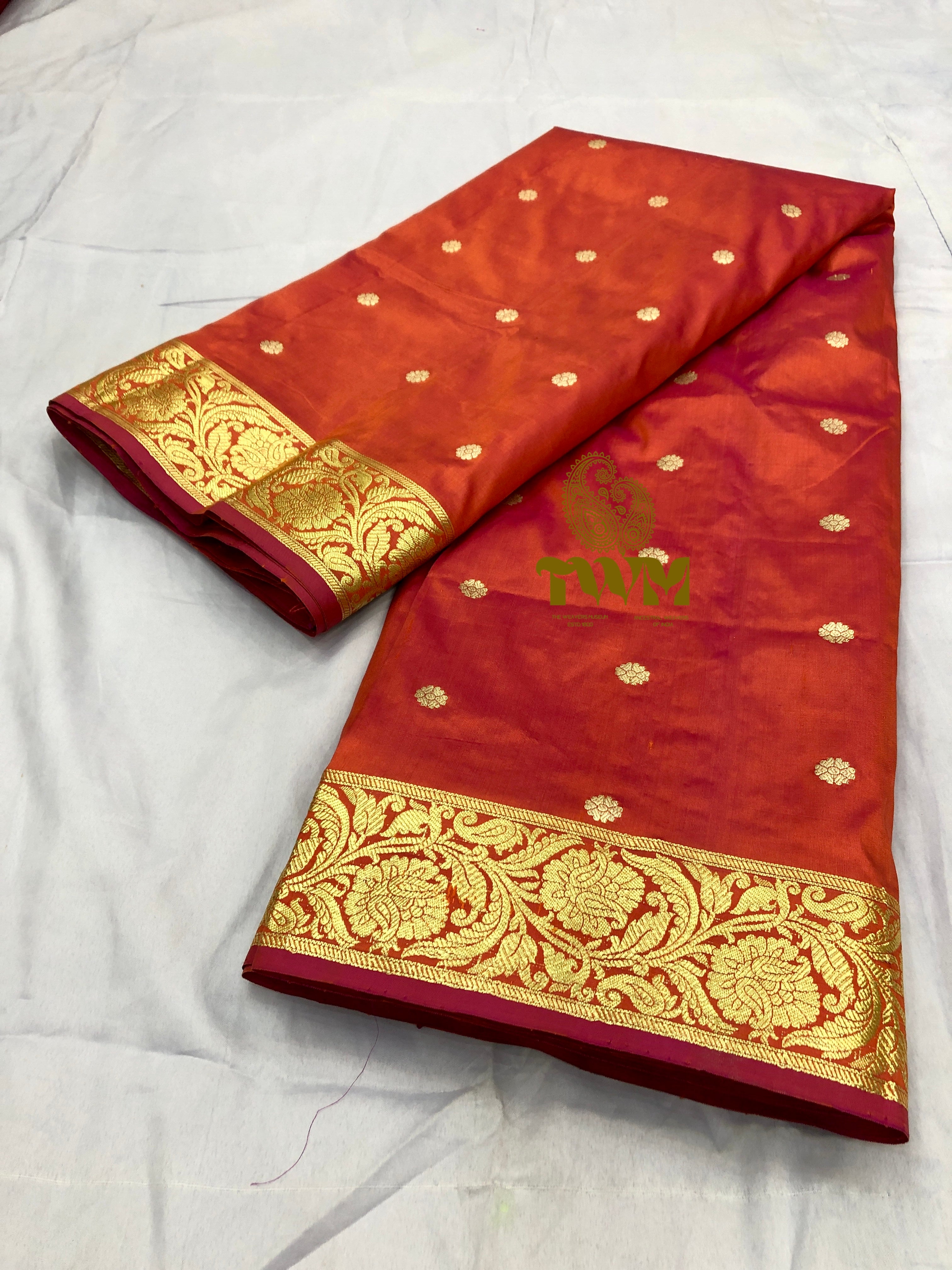 Orange dupatta with gold border and patterns on a white background
