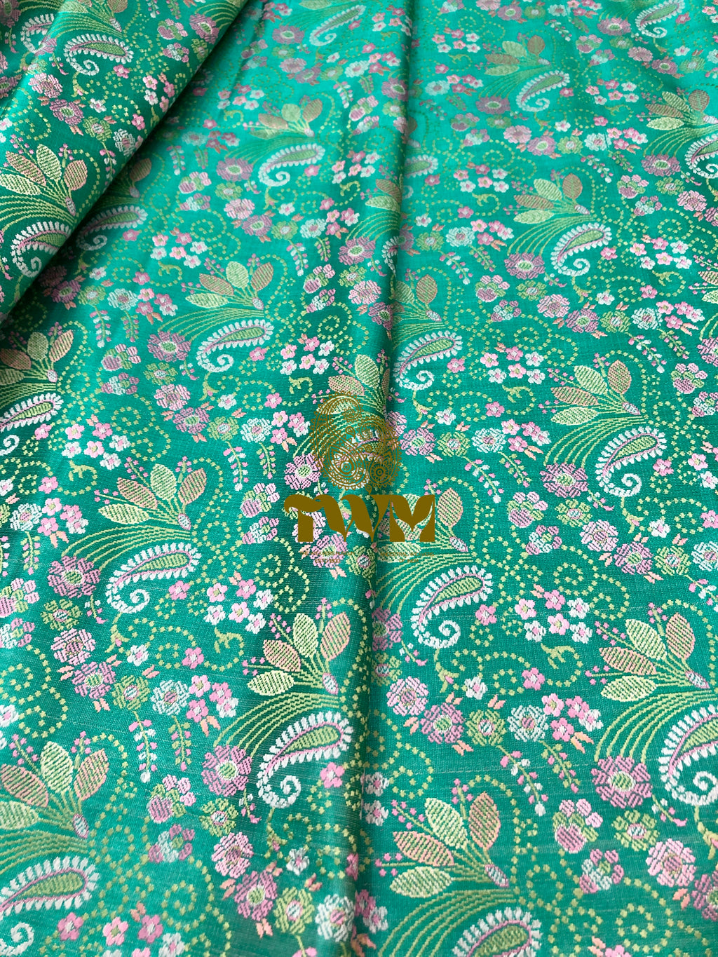 Green fabric with floral and paisley pattern