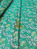 Green fabric with floral and paisley pattern