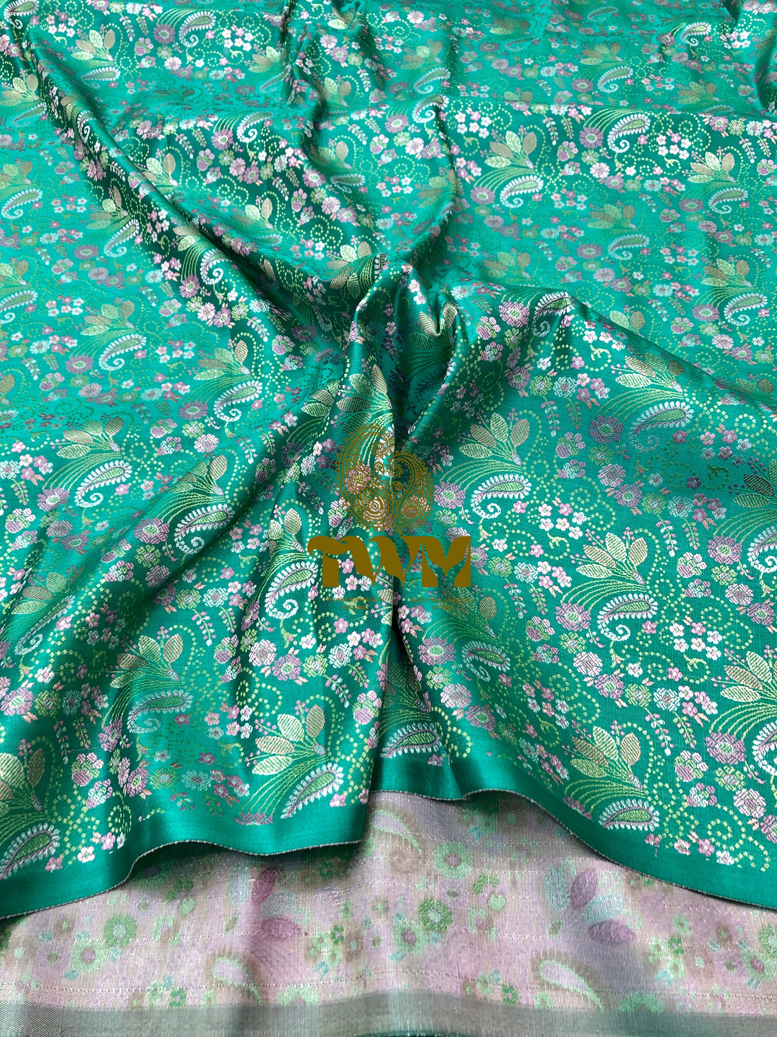 Green floral fabric with a brand logo in the center