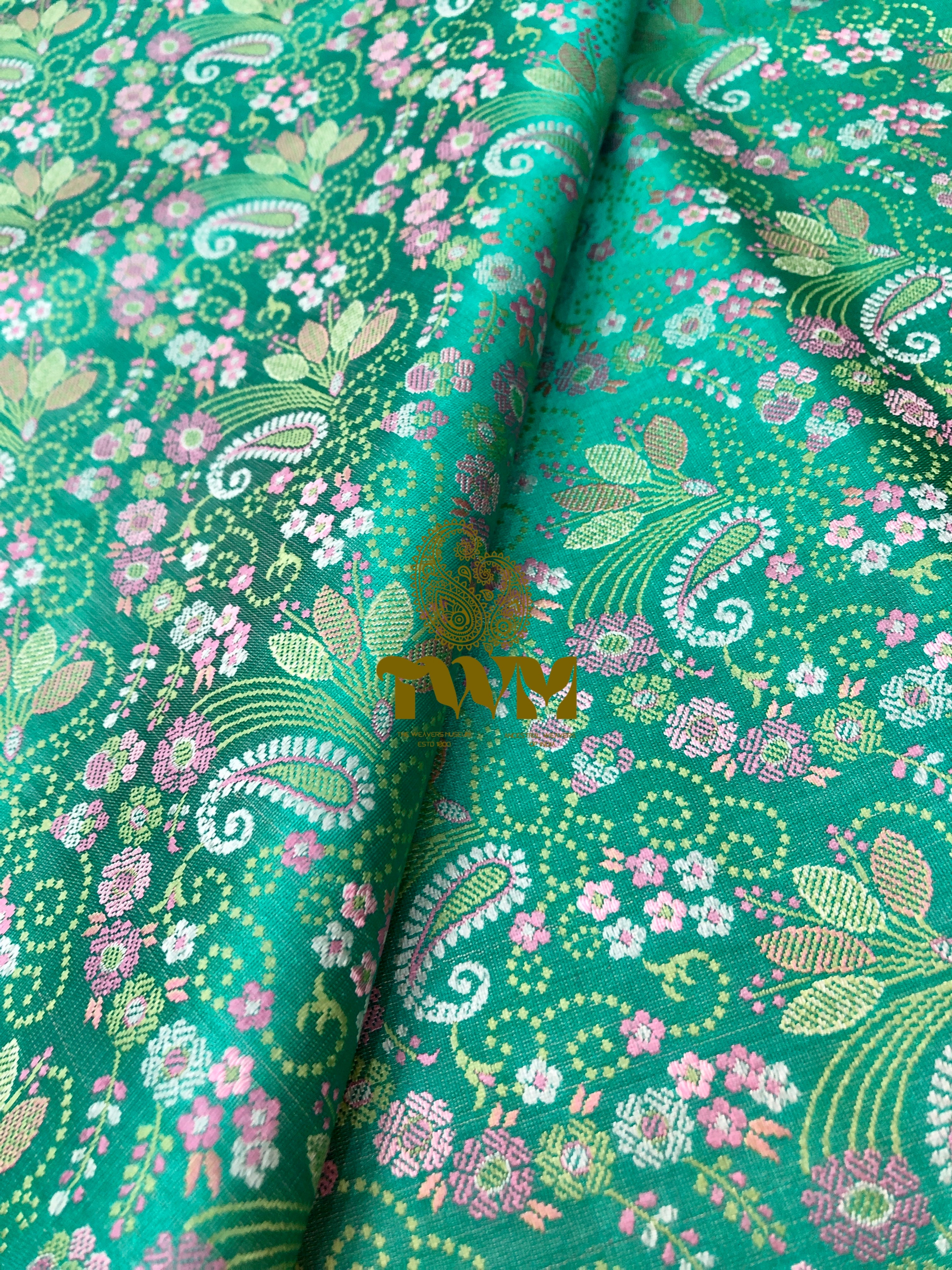 Green fabric with floral and paisley pattern
