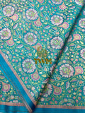 Teal fabric with floral pattern and 'TWM' text