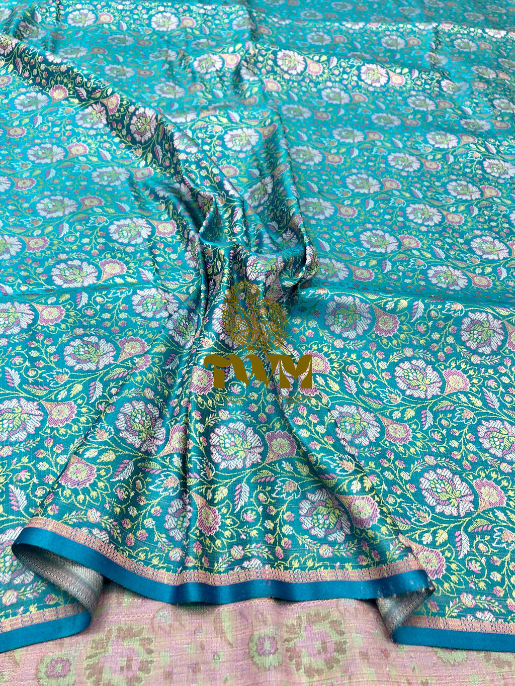 Teal floral patterned fabric with gold accents