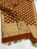 Brown and beige patterned fabric with tassels on a white background