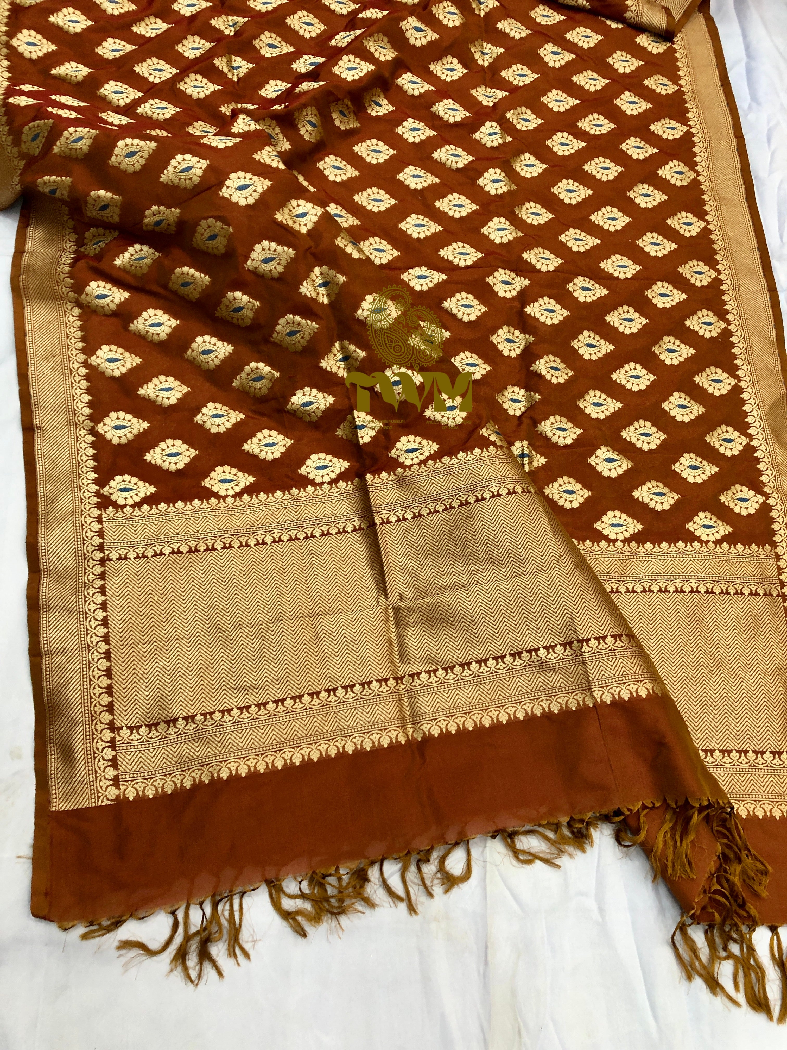 Brown and beige patterned fabric with tassels on a white background