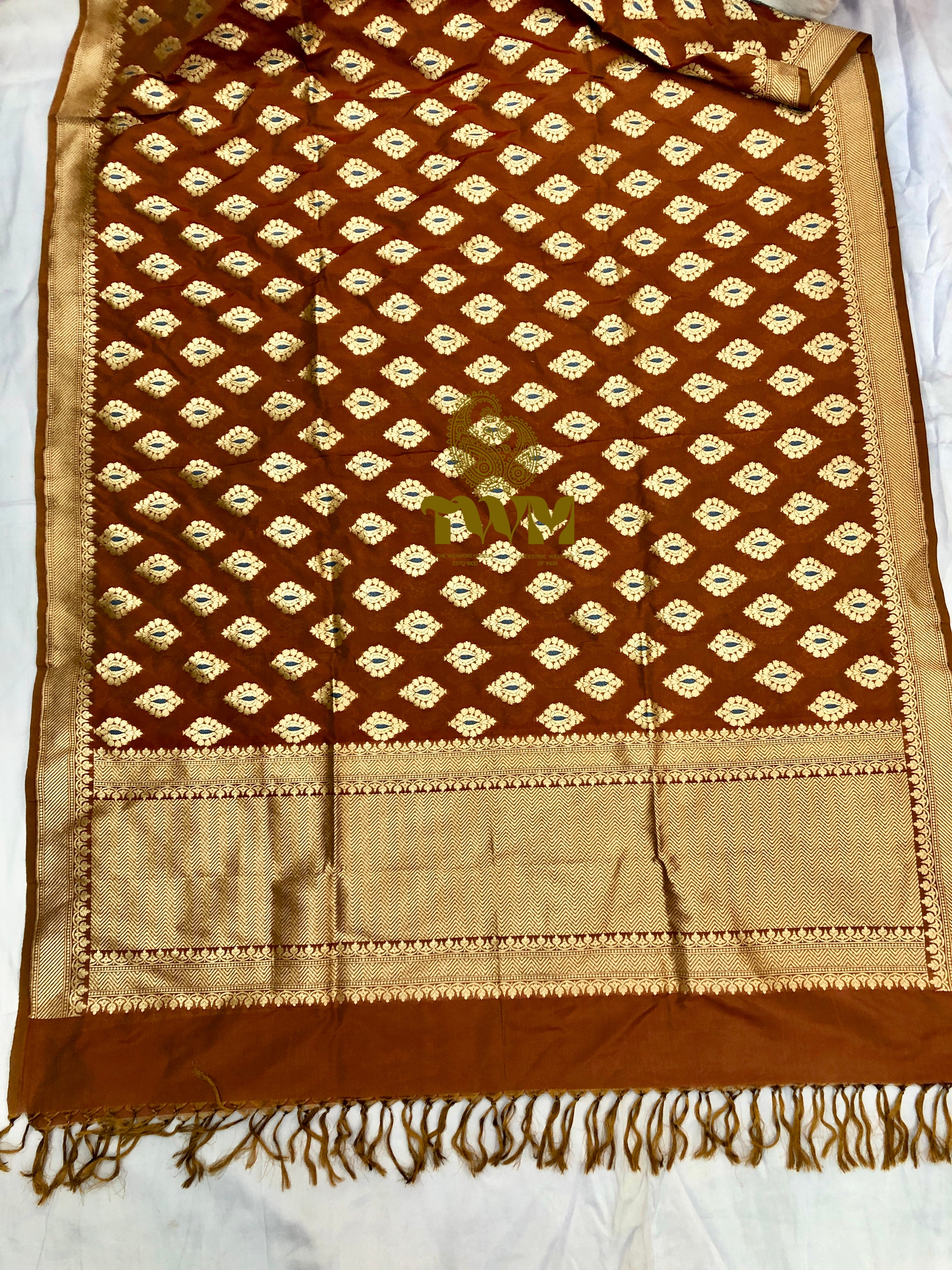 Brown and beige patterned fabric with fringes on a white background