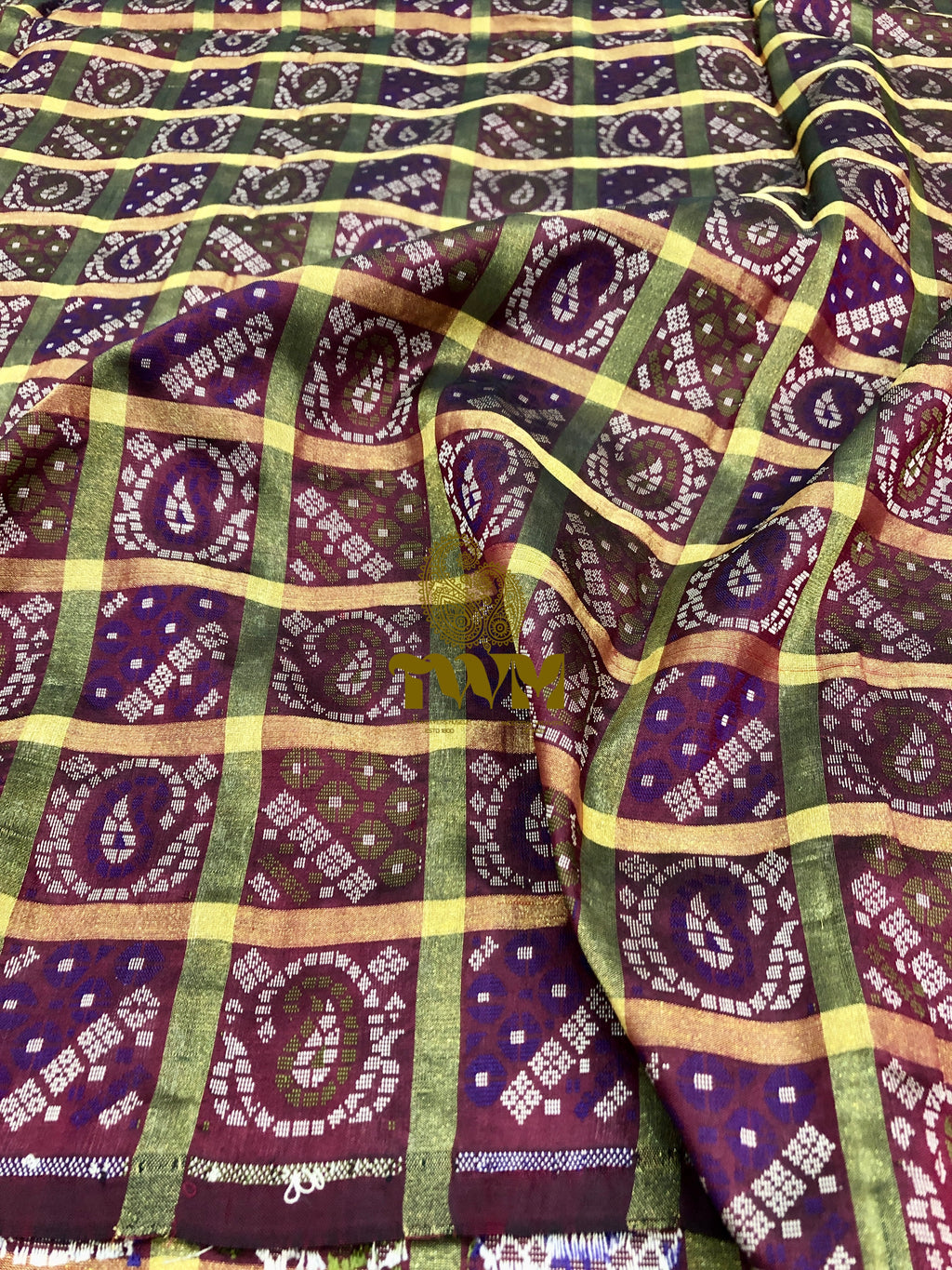 Patterned fabric with purple, green, and yellow colors